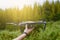 A man catching drone with his hand.Photographer controls a quadcopter drone to take aerial view photo and video in the forest