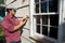 Man Caulking Window