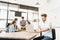 Man celebrate success pose with multi-ethnic diverse team meeting at office. Creative group, business coworker, or college student