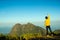 Man celebrating success on top of a mountain