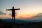 Man celebrating sunset looking at view in mountains