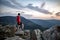 Man celebrating sunset looking at view in mountains