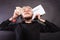 Man with chained hands holding contract and money