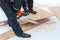 A man chainsaw sawing a wooden panel on a winter day on a background of snow