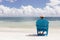 Man in chair on Caribbian beach