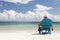 Man in chair on Caribbian beach