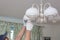 Man changes an electric light bulb, energy efficiency