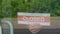 A man changes a sign that says OPEN for a sign that says CLOSED during the COVID-19 pandemic. Information plate on a