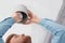 Man changing light bulb in pendant lamp indoors