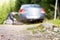 Man changing new spare wheel after vehicle hit rock on countryside sand road.