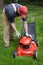 Man checking gas powered lawn mower