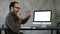 Man checking his teeth in the office near computer screen. White Display.