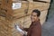 Man Checking Lumber In Warehouse