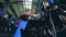 A man checking milking equipment in a cowshed, close up.