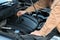 Man checking motor oil level in car with dipstick, closeup