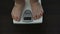 Man checking weight loss on scales, unhealthy nutrition, genetic predisposition