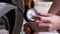 A Man Checks the Air Pressure in a Motorcycle Tire with a Pressure Gauge