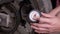 A Man Checks the Air Pressure in a Motorcycle Tire with a Pressure Gauge