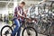 Man checks bike before buying in shop