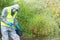 The man checks the duration of the protection of the special suit in the conditions of pollution, putting it on