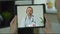 Man checks possible symptoms with professional physician, using online video chat. Man sick at home using digital tablet