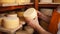 man cheesemaker in the cellar, beautiful wooden shelves with a