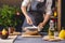 Man chef in a black apron kneading the dough with hands for Christmas baking. Joyful cooking for festive new year table