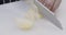 Man chef slicing onion for vegetarian lunch