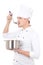 Man in chef uniform tasting something from saucepan isolated on