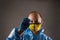 Man in chemical protection suit with virus in hands