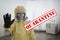 Man in chemical protective suit showing STOP gesture. Prevention of virus spread