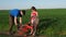 A man with a child is repairing a bicycle. Dad with a daughter with a bike in nature. The man is repairing the bicycle.