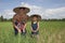 Man and child in the rice paddy, Thailand