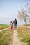 Man and child walking together in autumnal colorful nature in rural path
