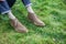 Man chilling on green grass wearing shoes and jeans.