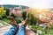 Man chilling on the rooftop sitting on the edge wearing leather shoes and enjoy the view of old town Prague, Czech Republic.