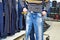 Man chooses blue jeans in shop