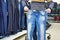 Man chooses blue jeans in shop