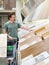 Man chooses floorboard laminate in shop