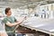 Man chooses floorboard laminate in store