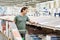 Man chooses floorboard laminate in store