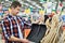 Man chooses snow shovel in store