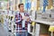 Man chooses wall tiles for bathroom in supermarket building mate