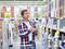 Man chooses wall tiles for bathroom in supermarket building mate