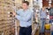 Man is choosing furniture fittings in tools store