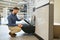 Man choosing home toilet in store