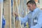 Man choosing various tools in garden equipment shop