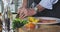 A man chopping herbs in a brightly lit kitchen