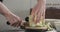 Man chopping iceberg lettuce on wood board