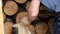 A man is chopping logs with an axe on chopping block. Harvesting of firewood stocks for heating.